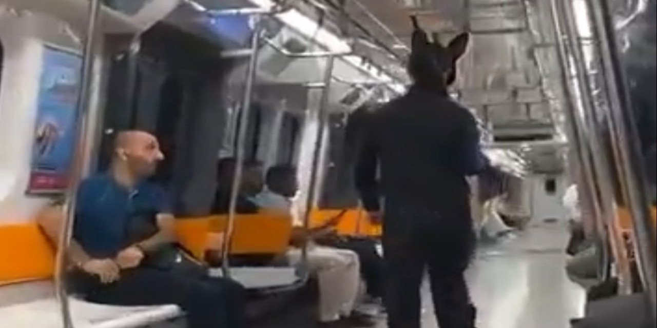 Yüzünde maske, elinde tüfek metroya bindi